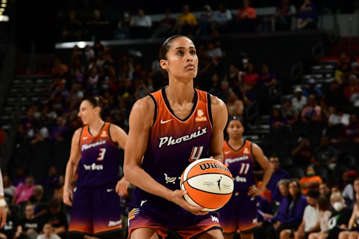 Phoenix Mercury player Skylar Diggins-Smith holds a basketball and prepares to shoot during a WNBA game.